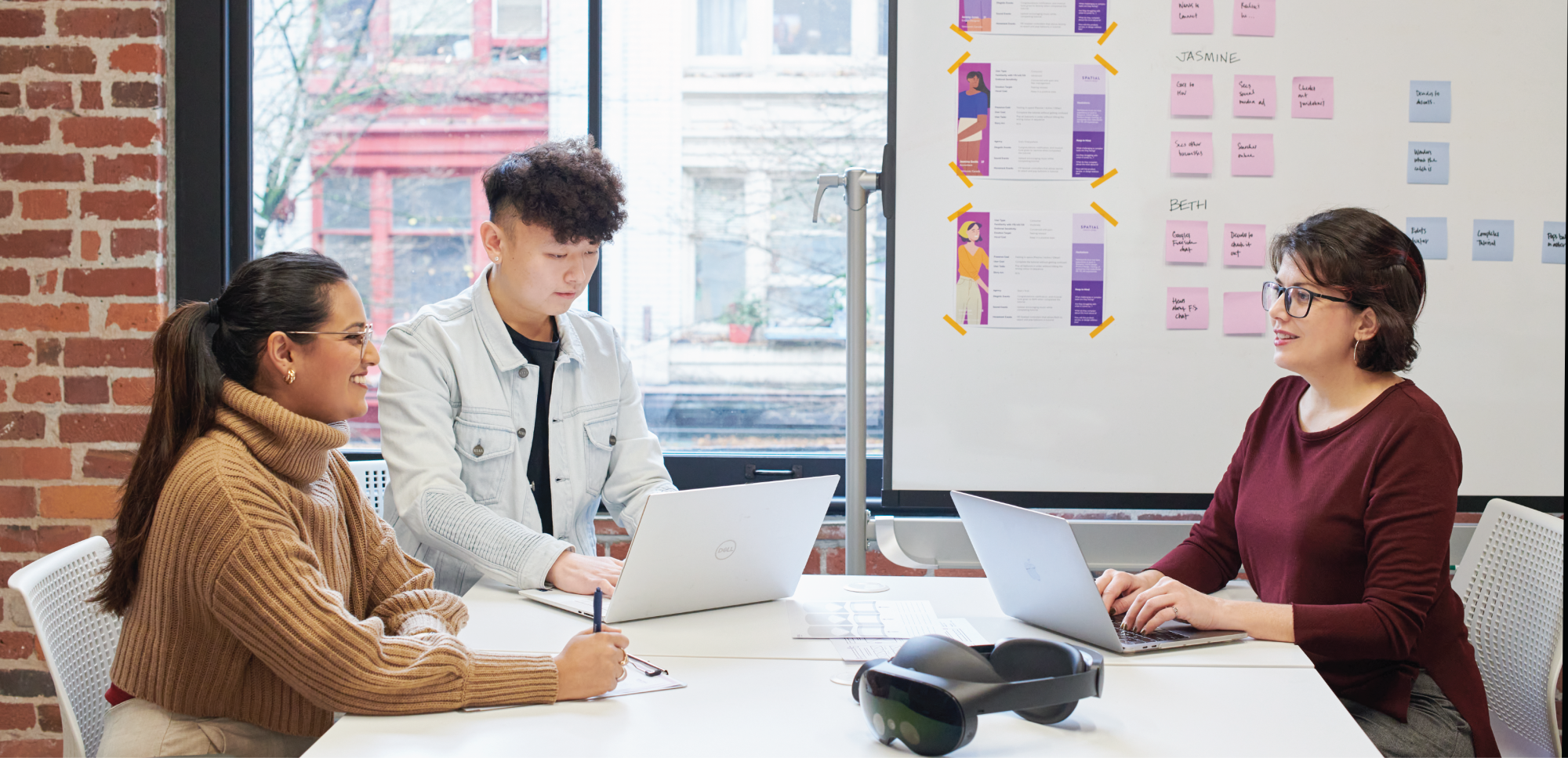 Researchers sitting at a table in a research lab.